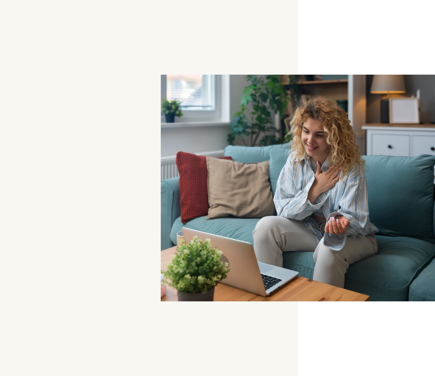 Woman video chatting on laptop at home.